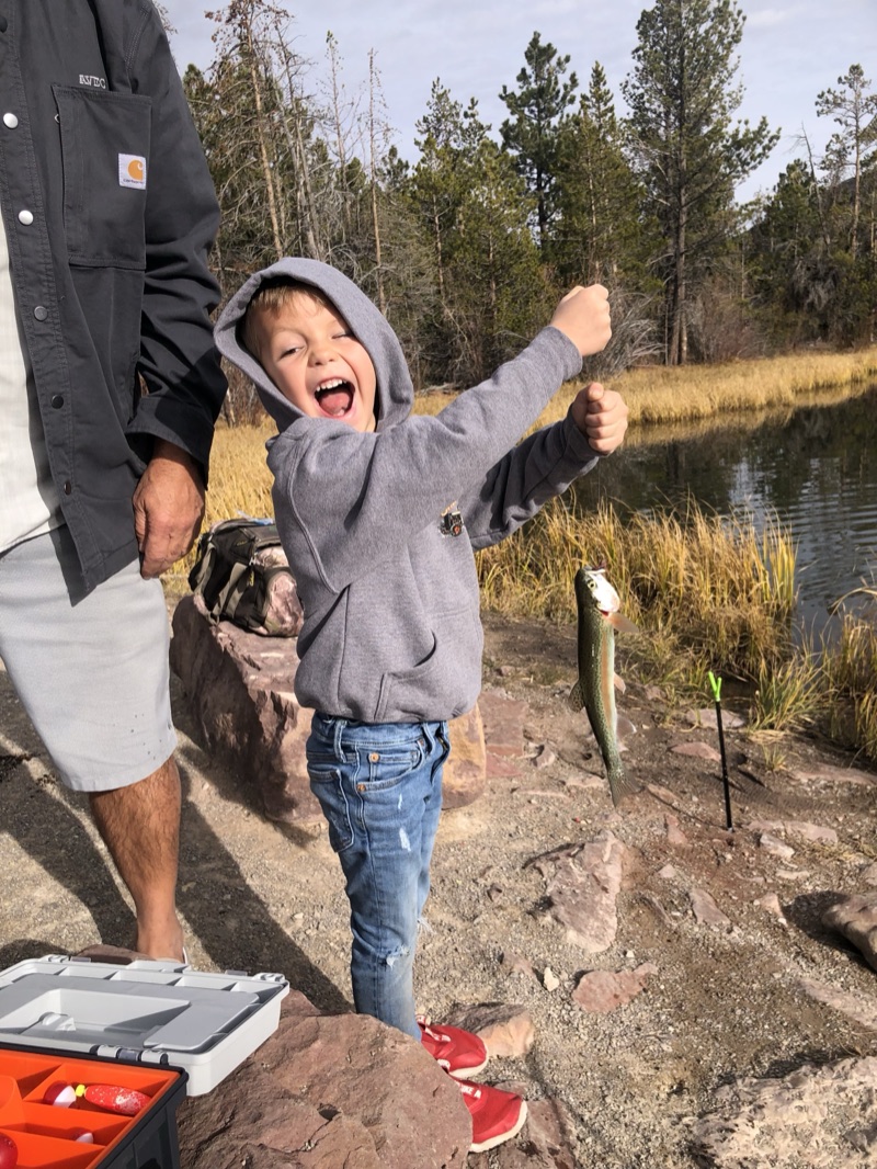 Ollie proudly holding up a trout he caught