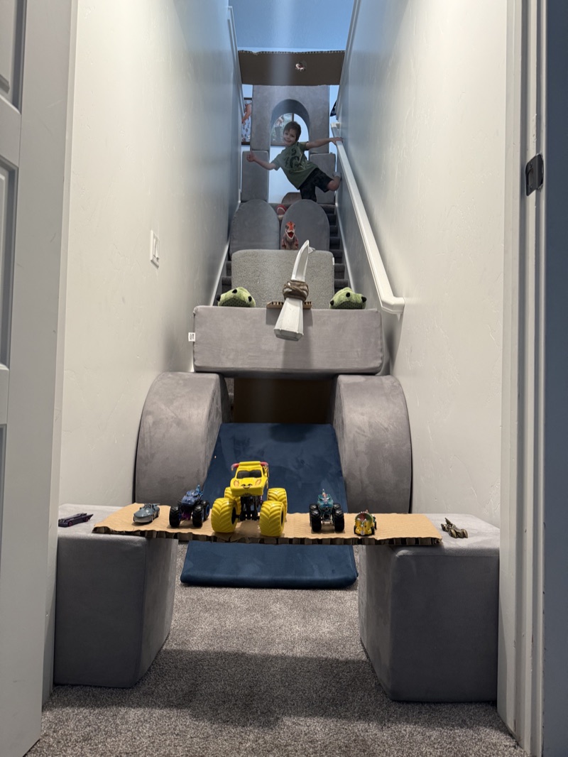 A blanket-and-cushion fort built into the stairwell